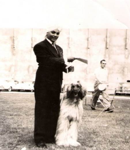 KORLA SHOWING ONE OF HIS AFGHAN HOUNDS